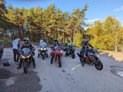 a group of people riding motorcycles on a road at Domaine de l'Adoux in Saint-Jean Montclar