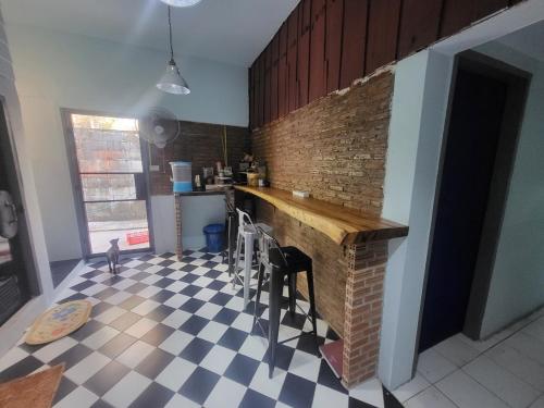 a kitchen with a counter and a brick wall at Punkei home-Chiang Mai Center Near Sunday Market in Chiang Mai