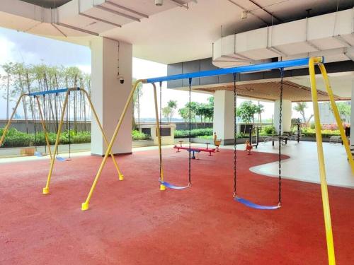 a large room with swings in a playground at Sofia Superior Suite 2R2B-51902 at R&F Princess Cove in Johor Bahru