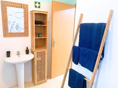 a bathroom with a sink and a towel ladder at Santana House - Holiday Rental by Your Key in Santana
