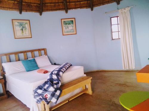 a bedroom with a bed in a room at Slubani in Eshowe