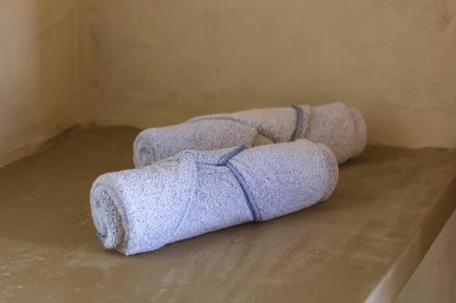three towels sitting on a counter in a room at Casa Caroá - Chalé 3 in Japaratinga