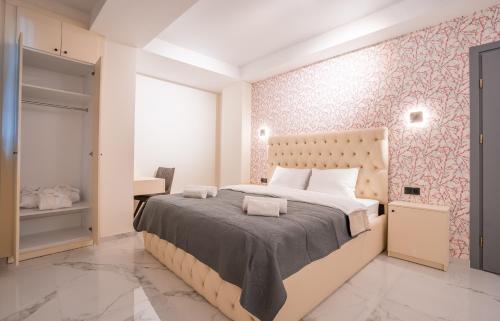 a bedroom with a large bed and a pink wall at Luxury X By umbrella in Tbilisi City