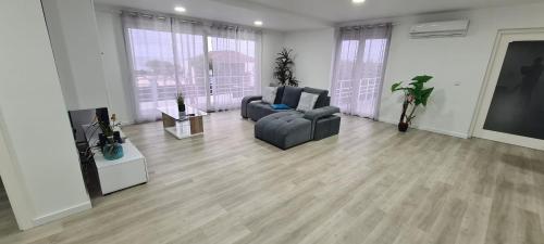 a living room with two couches and a flat screen tv at Azores Blue Bay in Madalena