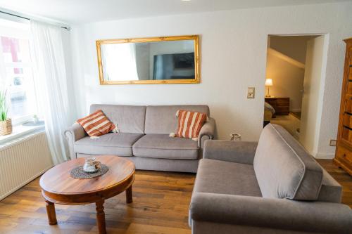 a living room with a couch and a table at Sabina Ferienhaus in Trebbin