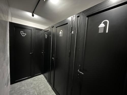 a row of black lockers in a locker room at Mickitos Urban Hostel in Skopje