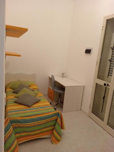 a bedroom with a bed and a desk and a desk at MaryAlex in Punta Secca