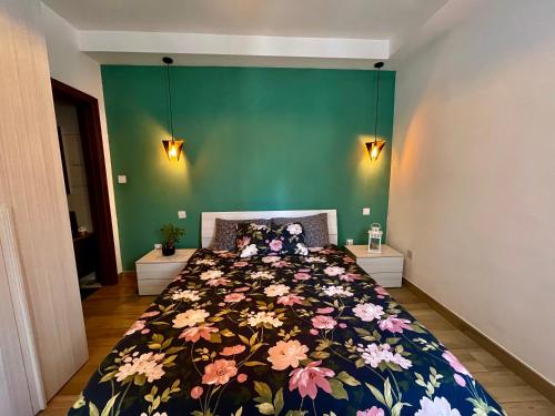 a bedroom with a large bed with a floral bedspread at Airport Accommodation Deluxe Bedroom and Private Bathroom near Airport Self Check In and Self Check Out in Mqabba