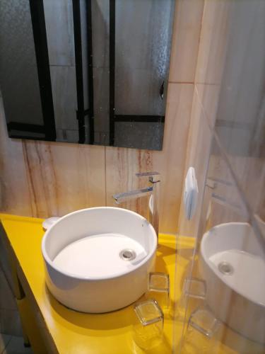 a bathroom with a white sink and a mirror at Villa Garita Inn in La Garita