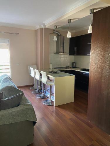 a kitchen and living room with a couch and a table at Mollys2apartment in Pogradec