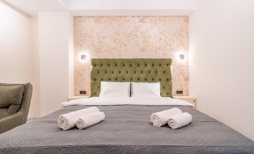 a bedroom with a bed with two towels on it at Luxury X By Umbrella in Tbilisi City