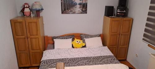 a bedroom with a bed with a rubber duck on it at Apartman Jonjić in Kupres