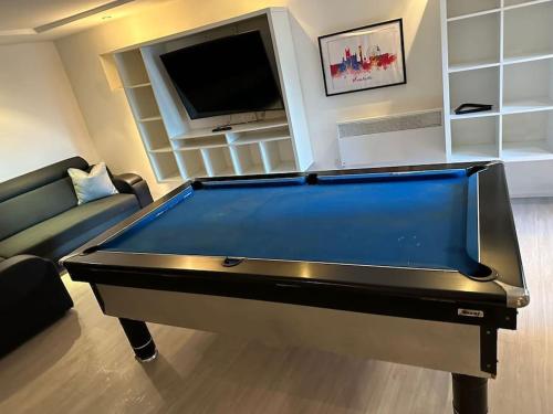 a living room with a pool table and a tv at Entire Modern Studio Apartment with Pool Table in Denton