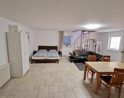 a living room with a couch and a table at Schönes Apartment / Ferienwohnung am Regen in Blaibach