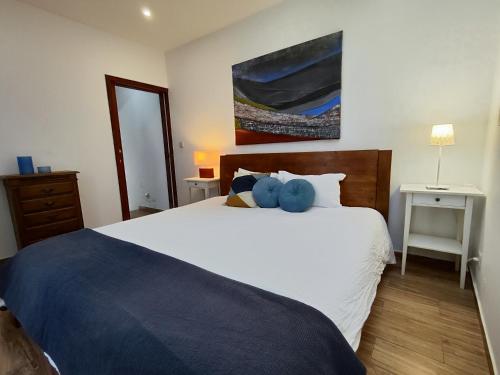 a bedroom with a bed with a blue stuffed animal on it at O'Porto Cheers Gaia in Vila Nova de Gaia