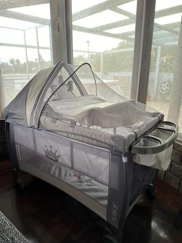 an empty baby crib in a room with a window at Casa dos Amigos Panoramic View in Funchal