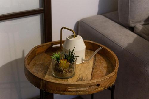a coffee table with a candle and a plant on it at Grand appartement spacieux - Proche Paris in Sèvres