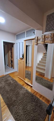 a room with a staircase and a living room at Apartman Jonjić in Kupres