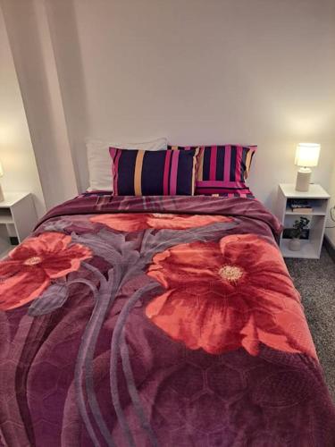 a bedroom with a bed with two red flowers on it at 1 Bedroom Flat Available in Oldham