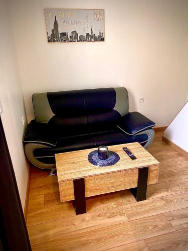 a living room with a couch and a coffee table at Maison cocooning in Châteauroux