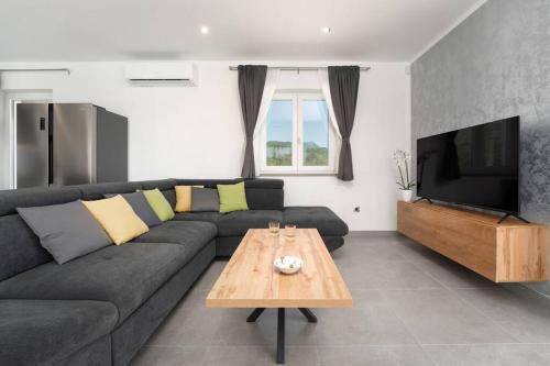 a living room with a couch and a table at Villa HillSea in Mošćenice