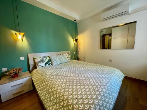 a bedroom with a bed and a mirror on the wall at Airport Accommodation Bedroom with your own private Bathroom Self Check In and Self Check Out Air-condition Included in Mqabba