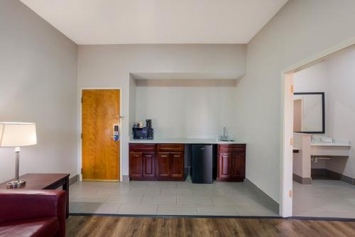 an empty living room with a kitchen and a couch at Rodeway Inn in Brandon