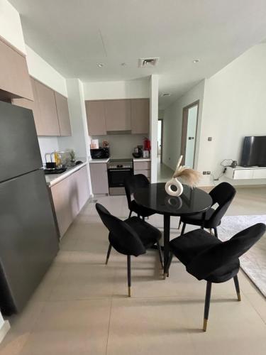 a kitchen and dining room with a table and chairs at 2 Bedrooms Apartment Burj khalifa and fountain view in Dubai