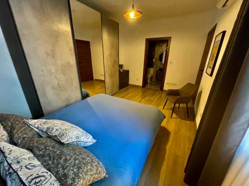 a room with a bed and a hallway with a chair at Airport Accommodation Bedroom with your own private Bathroom Self Check In and Self Check Out Air-condition Included in Mqabba