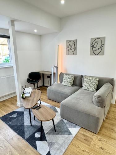 a living room with a couch and a table at The Modern Smart Home in Great Warley Street