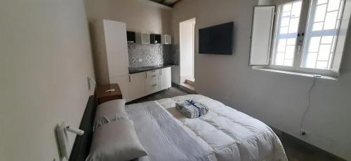 a bedroom with a bed in a room with a window at Casa Stella in Genzano di Roma