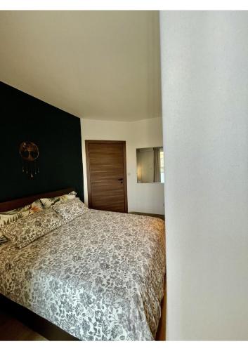 a bedroom with a bed and a black wall at Airport Accommodation Bedroom with Bathroom, balcony, aircondition, self checkIn, 24 hours check-in after 3pm in Mqabba
