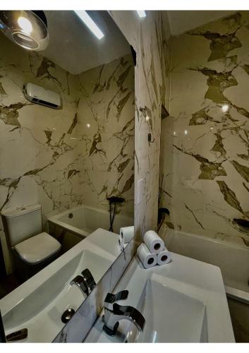 a bathroom with a sink and a bath tub at Airport Accommodation Bedroom with Bathroom, balcony, aircondition, self checkIn, 24 hours check-in after 3pm in Mqabba