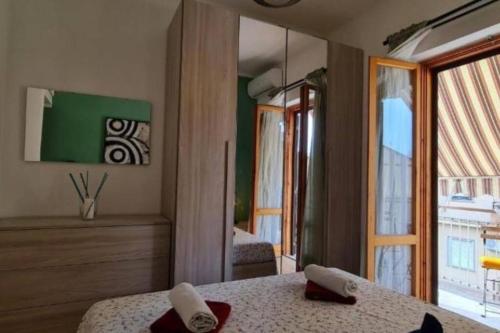 a bedroom with a bed and a large window at Little Home in Bolsena