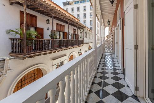 a hallway of a building with a black and white checkered floor at Hotel Casa del Gobernador in Cartagena de Indias