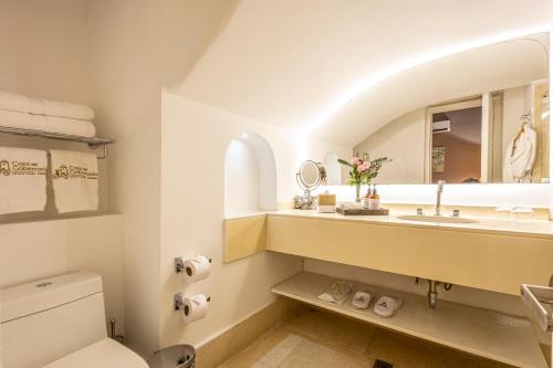 a bathroom with a sink and a mirror at Hotel Casa del Gobernador in Cartagena de Indias