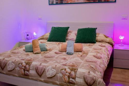 a bedroom with a large bed with green pillows at Urban loft - Purple loft in Turin