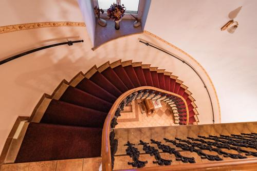 a staircase in a building with a stair case at Penzion Věžička in Lázně Bělohrad