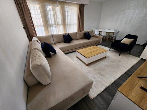 a living room with a couch and a table at Residence Al Kasbah - VacayX - Chic Triplex 3BR -RABAT in Rabat