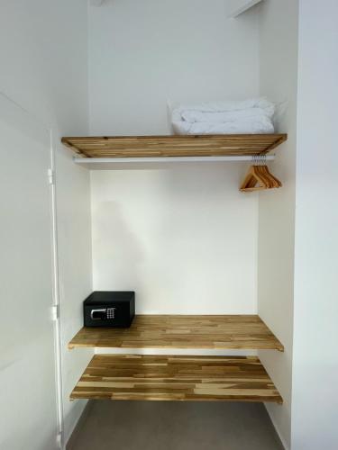 a small room with wooden shelves and a bed at Emeraude Bay, Magnifique T3 vue mer, proche plage in Le Gosier