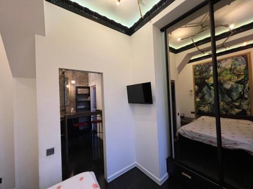 a room with a bed and a mirror at Center Apartment in Chişinău