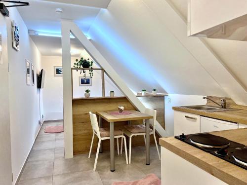 a kitchen and dining room with a table at Apartmán U Bobovky - Lipno nad Vltavou in Lipno nad Vltavou