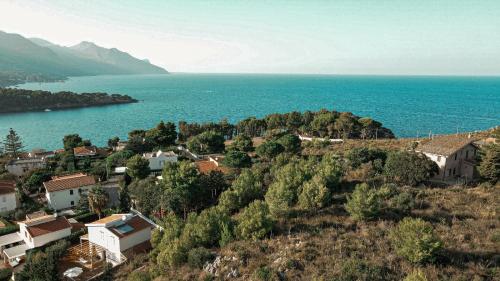 a small town on a hill next to the water at LE SORELLE entire villa sea view in Scopello
