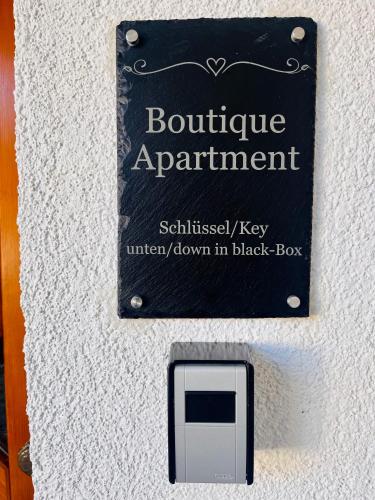 a sign for aoutine appointment on a wall at Boutique Apartment in Lenzkirch