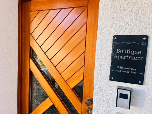 a wooden door with a sign in front of it at Boutique Apartment in Lenzkirch