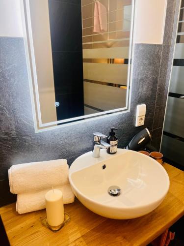 a bathroom with a sink and a mirror at Boutique Apartment in Lenzkirch