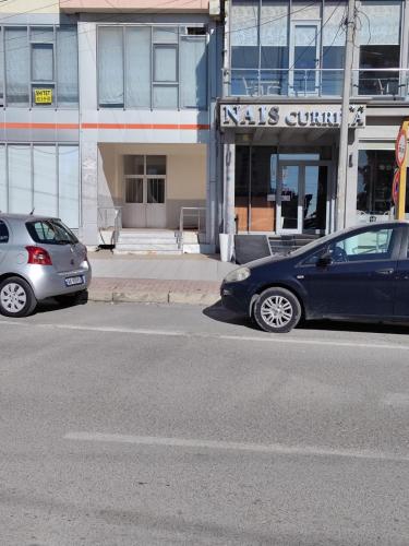 two cars parked on the side of a street at NOVA Sea View Apartments in Durrës