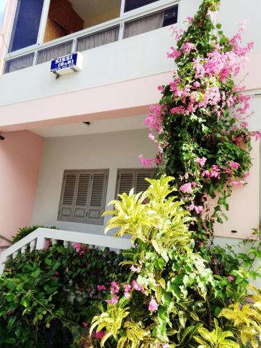 a house with pink flowers on the side of it at Sissi's B&B in Ponta do Sol