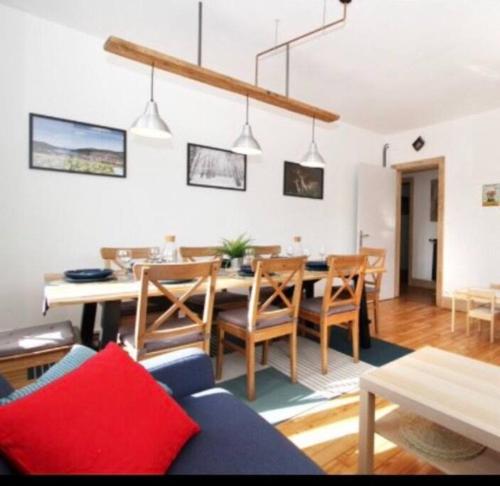 a living room with a dining room table and chairs at Charmant appartement en centre ville in Gérardmer