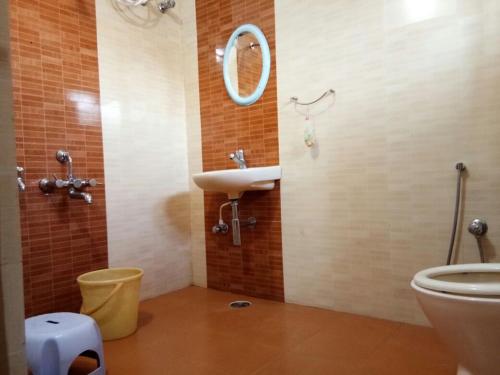 a bathroom with a sink and a toilet at Coorg nest Home stay in Madikeri